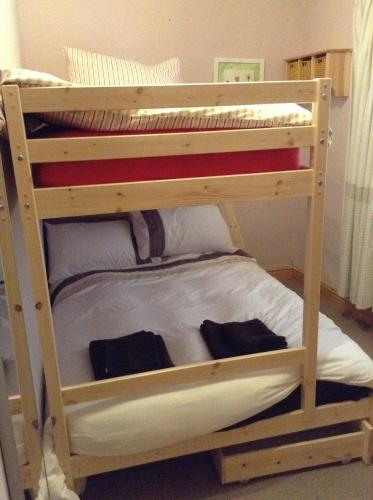 a wooden bunk bed with two sets of bunk beds at Red Dragon Cottages nr Mt Snowdon in Beddgelert