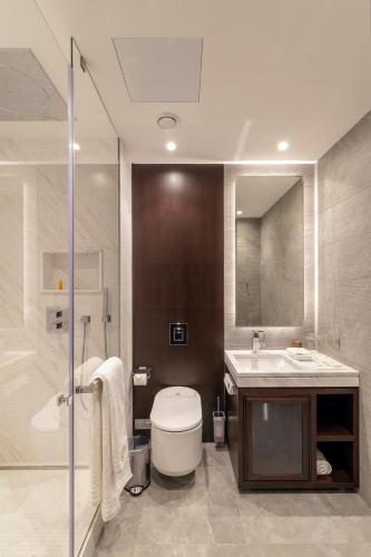 a bathroom with a toilet and a sink and a shower at SOHO boutique hotel in Dnipro