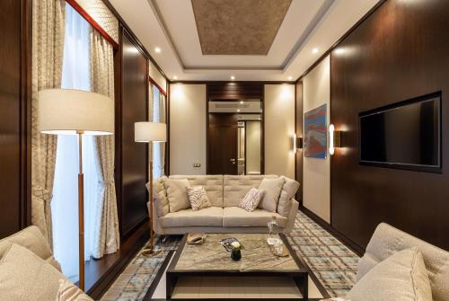 a living room with a couch and a tv at SOHO boutique hotel in Dnipro