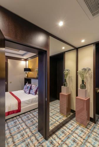 a hotel room with a bed and a mirror at SOHO boutique hotel in Dnipro