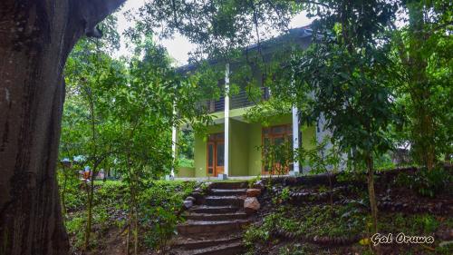 a white house with stairs in front of it at Gal Oruwa Resort in Dambulla