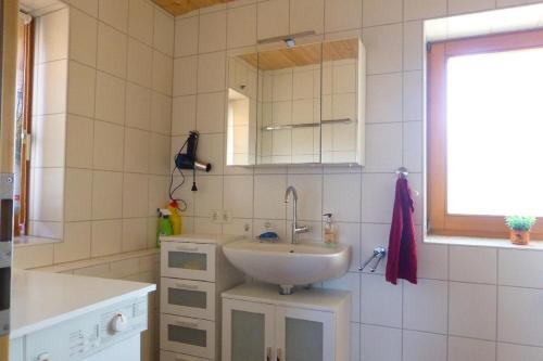 a bathroom with a sink and a mirror at Haus Schloßwiese in Bad Füssing