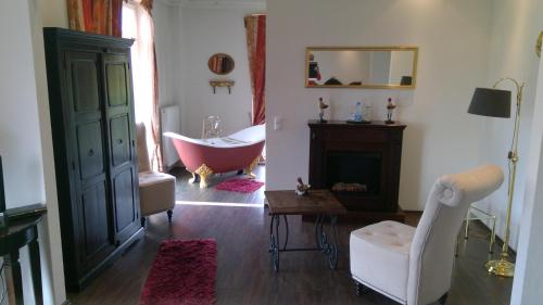 a bathroom with a bath tub and a claw foot bath tub at Gästehaus Chalet Ochtrup in Ochtrup
