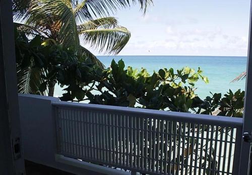 a view of the ocean from the balcony of a house at Hosteria del Mar in San Juan