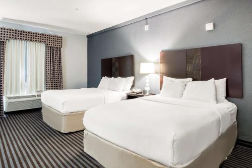 a hotel room with two beds and a window at Motel 6-Mineral Wells, TX in Mineral Wells
