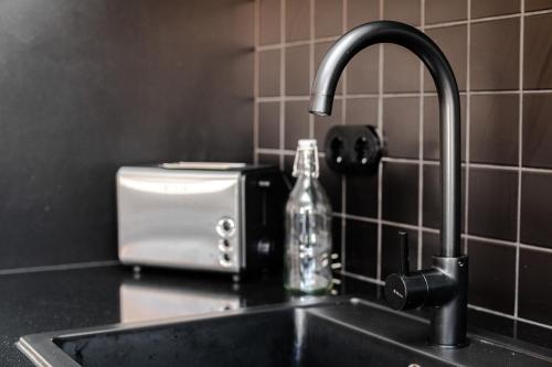 a kitchen sink with a soap bottle next to a toaster at Nomad's Family - 2BED Spacious Apartment Gaia in Vila Nova de Gaia