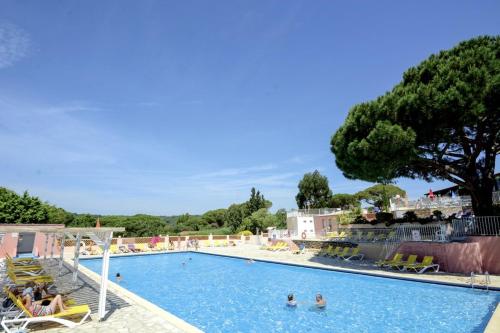 a large swimming pool with people in the water at Camping Montana Parc - Gassin Golfe de St Tropez - Maeva in Gassin