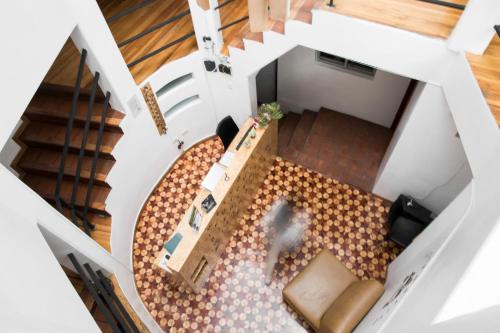 an overhead view of a living room with a staircase at AlterNative Hostels in Cuenca