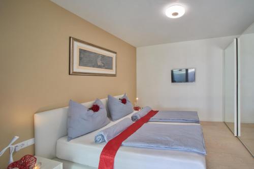 a bedroom with a bed with a red ribbon on it at Penthouse & Garden - luxury apartment in Postal