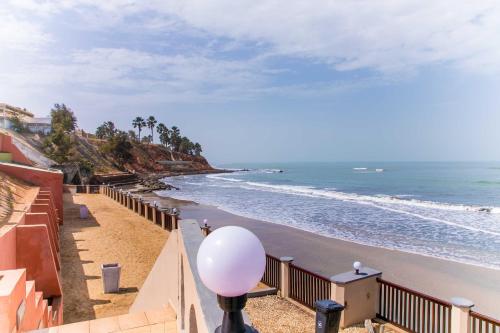 a view of the beach from the balcony of a house at Tropic Garden Hotel in Bathurst