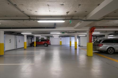 a parking garage with two cars parked in it at Bükkös Hotel & Spa in Szentendre