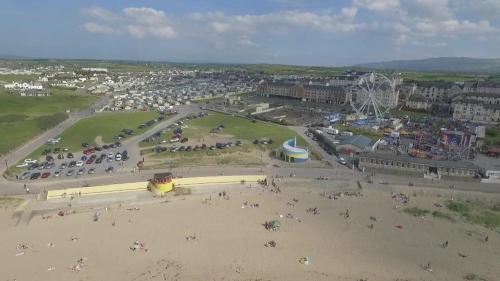 an aerial view of a beach with a crowd of people at 37 Atlantic Point, Ground Floor, Sea View Apartment sleeps 6 in Bundoran