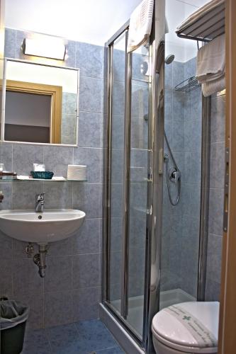 a bathroom with a shower and a sink and a toilet at Hotel La Scaletta in Lido di Ostia