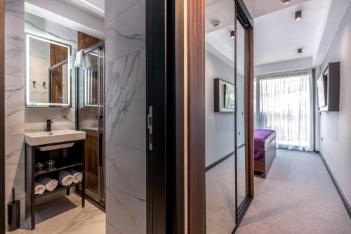 a bathroom with a sink and a mirror at Hotel Ad Turres in Crikvenica