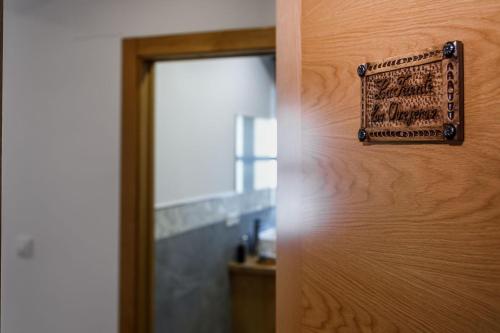 a close up of a door with a sign on it at Posada rural Fuente Juliana in Barrio de Arriba