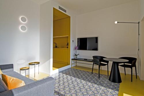 a living room with a couch and a table at Toraldo Suites - Dimore Partenopee in Naples