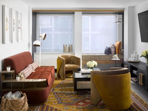 a living room with a couch and chairs at Vignette Collection Yours Truly DC by IHG in Washington