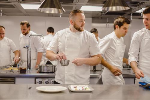 two chefs preparing food in a kitchen at Whatley Manor in Malmesbury