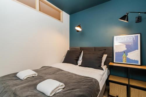 a bedroom with a bed with two pillows on it at Seaside Apartment Kraszewskiego by the Beach in Sopot by Renters in Sopot