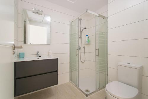a bathroom with a shower and a toilet and a sink at 58 Luxury Sunny Vacations in La Mata
