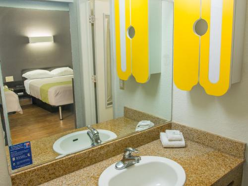 a hotel bathroom with a sink and a mirror at Studio 6-San Antonio, TX - Lackland AFB in San Antonio