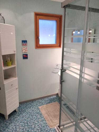 a bathroom with a shower with a glass door at Chambre de l'Orée du Bois in Audeux