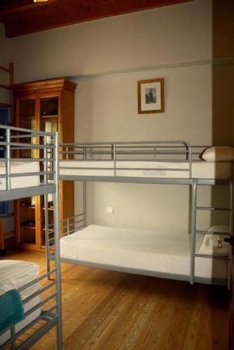two bunk beds in a room with wooden floors at El Cotillo de San Jose in Hinojos