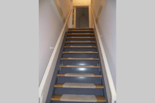 a staircase in a building with blue steps at Villa Greve - Maisonette Suite in Bad Salzuflen