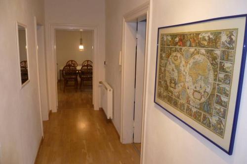 a hallway with a painting hanging on a wall at Villa Greve - Maisonette Suite in Bad Salzuflen