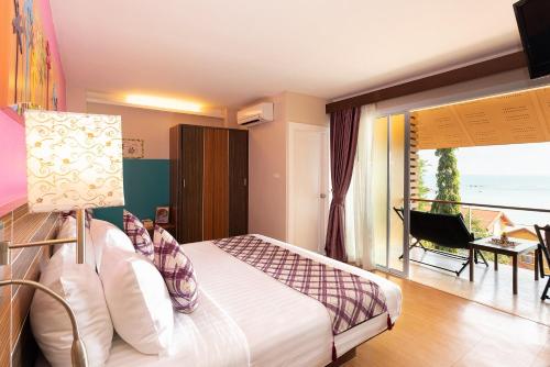 a bedroom with a bed and a balcony at Palm Coco Mantra in Lamai