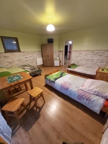 a bedroom with a large bed and a table and chairs at Dom pod Winogronem in Szczawnica