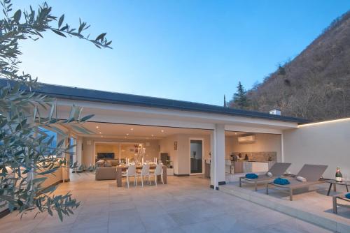 a house with a large patio with chairs and tables at Penthouse & Garden - luxury apartment in Postal