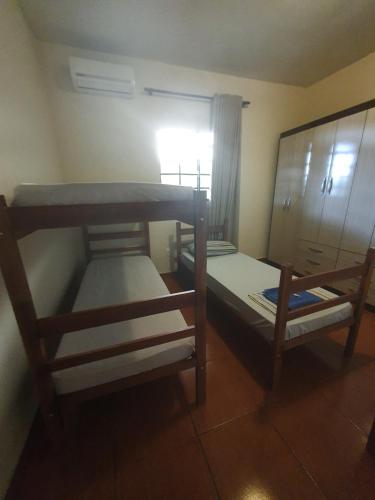 a room with two bunk beds and a window at Hostel Jussa in Belo Horizonte