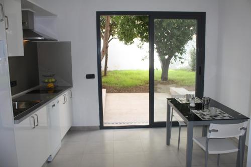 a kitchen with a table and a view of a yard at Residencia Mayol - Adults Only in Palma de Mallorca