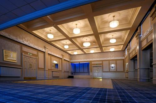 a large room with a dance floor and lights at The Corner House Hotel in Annan