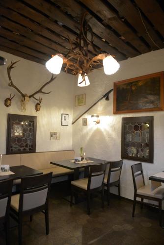a dining room with tables and chairs and a ceiling at Hotel- Landgasthof Baumhof-Tenne in Marktheidenfeld