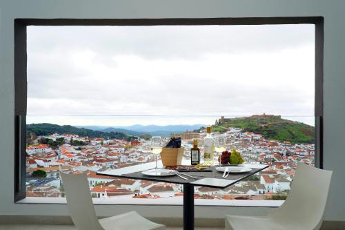 a table and chairs with a view of a city at Barceló Aracena & Spa in Aracena