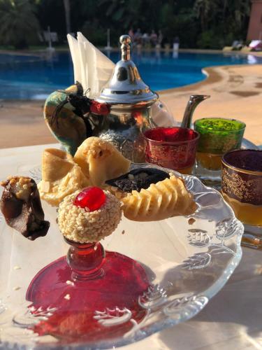 a glass plate of food on a table at Riad Noumidya in Fès