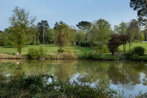 a view of a golf course from across a lake at Kilworth House Hotel and Theatre in Lutterworth