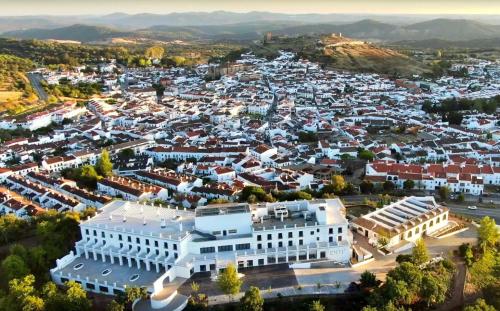 an aerial view of a city with a white building at Barceló Aracena & Spa in Aracena