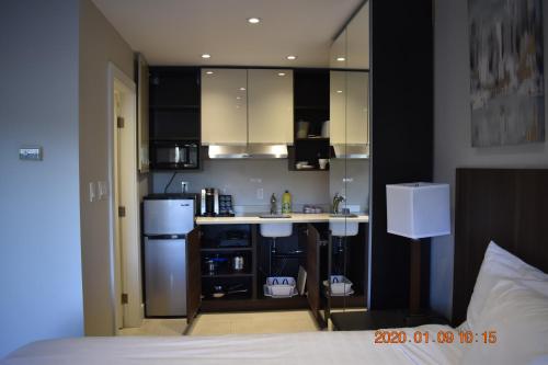 a small kitchen with a counter and a refrigerator at High Point Resort in Quathiaski Cove