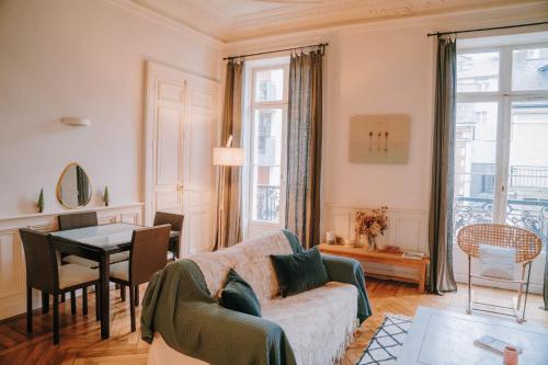 a living room with a couch and a table at Chez Angèle in Rennes