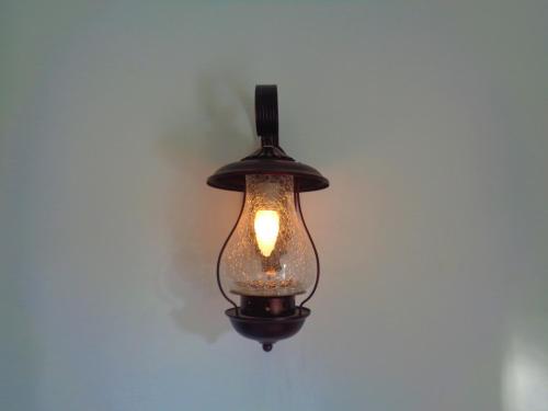 a black light fixture hanging on a wall at New Holiday Reach in Unawatuna