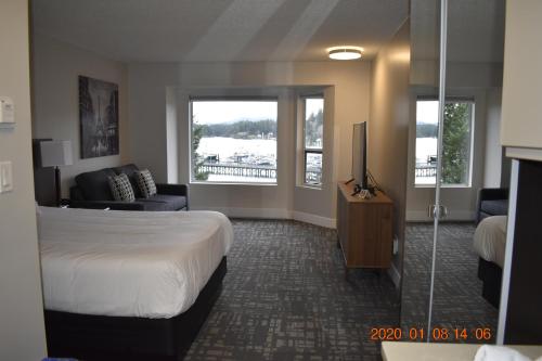 a hotel room with a bed and a television at High Point Resort in Quathiaski Cove