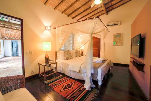 a bedroom with a bed with a canopy at Hotel e Resort Villas de Trancoso in Trancoso