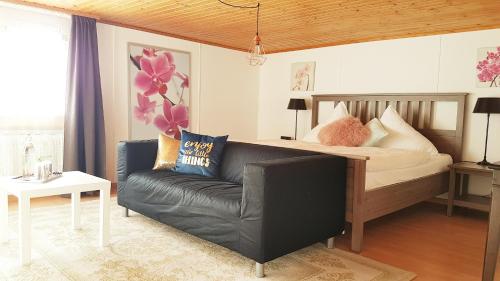 a living room with a bed and a couch at Family Mountain View - Upper Alley in Buchs