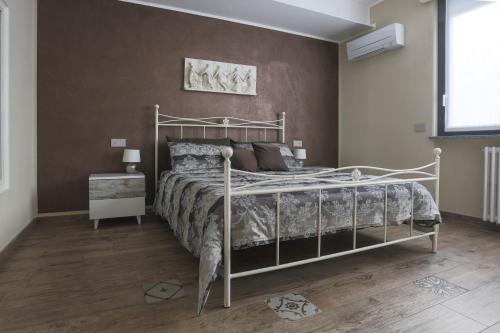 um quarto com uma cama com uma estrutura de metal em Elga's Apartment - Your charming stay on Lake Orta em Pettenasco
