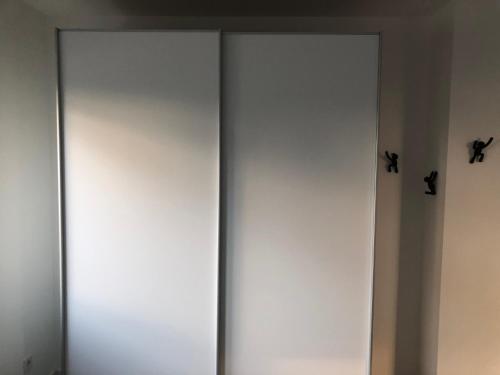two white doors with two crosses on the wall at Deluxe Apartments Messe Flughafen in Leinfelden-Echterdingen