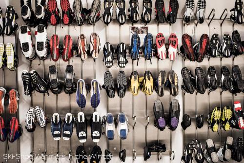 a wall filled with lots of different types of shoes at Sporthotel Pontresina in Pontresina