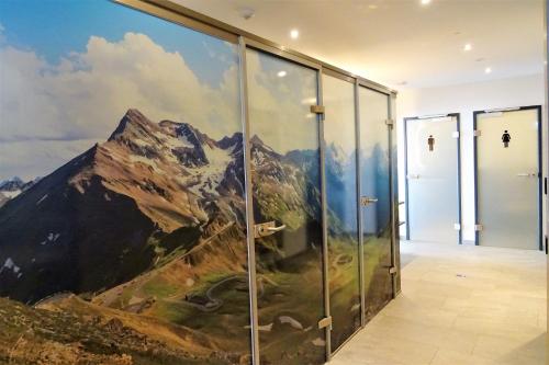 a mural of a mountain on a wall in a hallway at Hotel Römerhof in Fusch an der Glocknerstraße